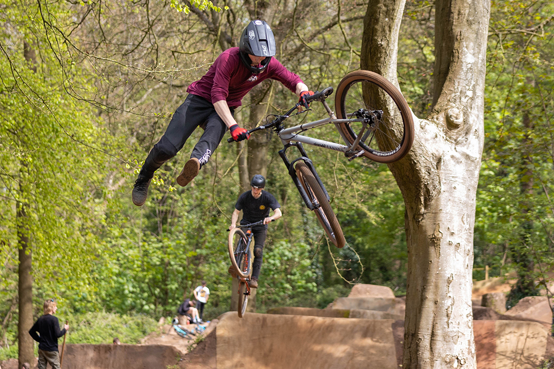 BMX rider jumps from his bike over a high jump